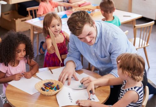teacher-and-pupils-practicing-writing-in-montessori-school