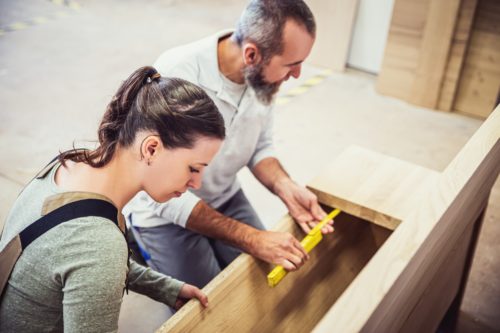 male-and-female-carpenter-at-work-man-and-woman-are-crafting-with-wood-in-a-workshop