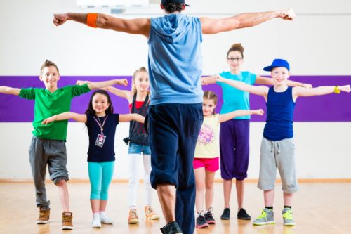 dance-teacher-giving-kids-zumba-fitness-class