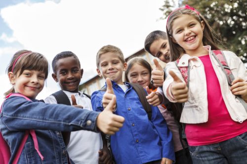 Group of mixed-race kids thumb up to camera