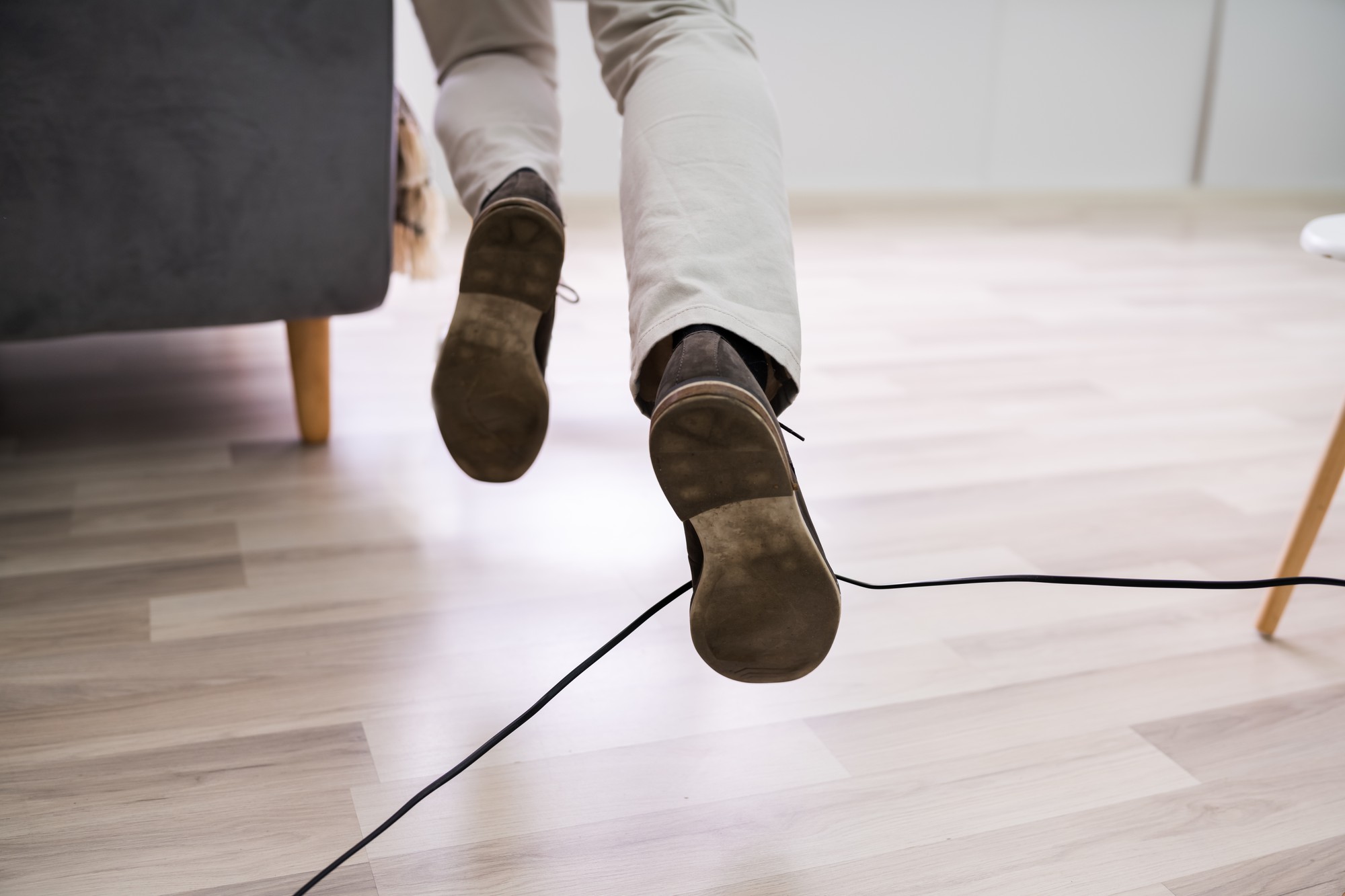 Man Legs Stumbling With An Electrical Cord