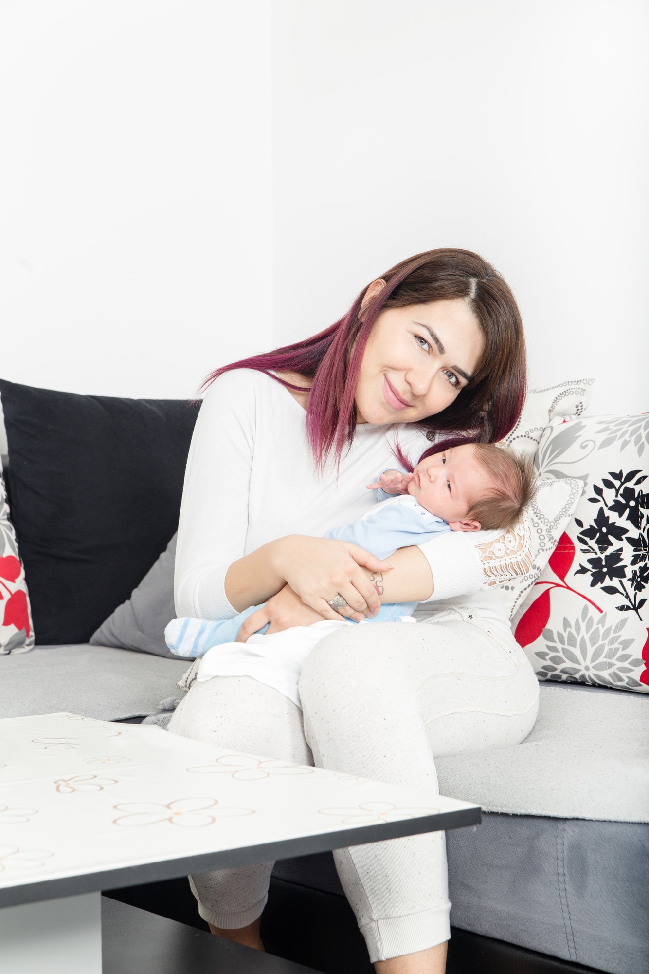 Healthy Woman and New Born Boy Relax in White Bedroom or Living
