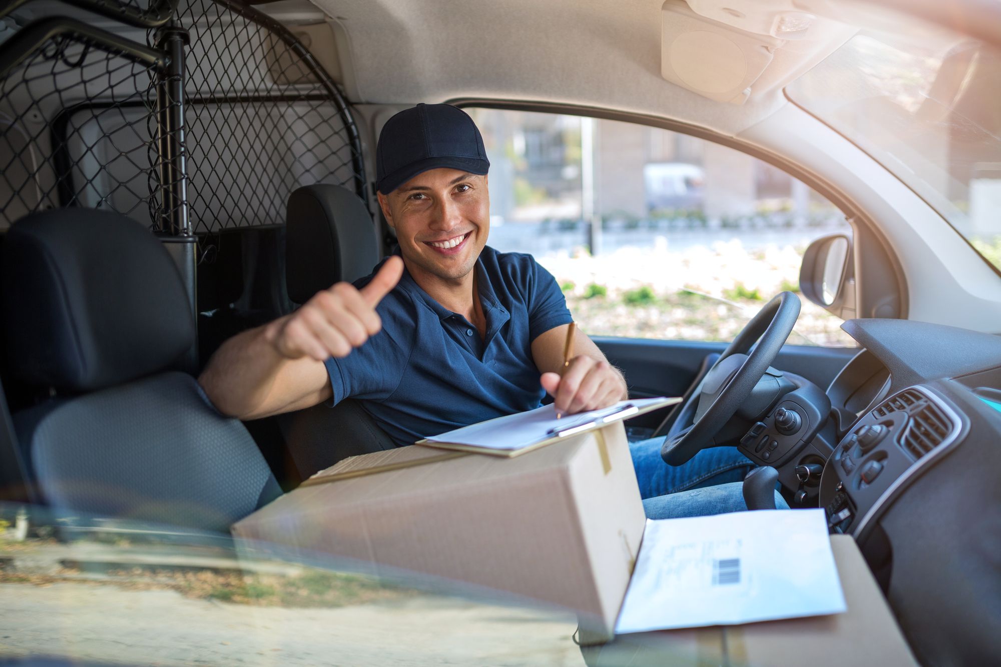 Delivery man sitting in a delivery van